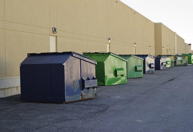 a row of yellow and blue dumpsters at a construction site in Cecilia KY